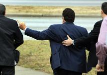 Harry Siskind gives a one-finger salute to the media